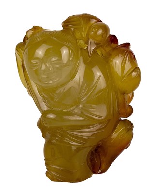 Lot 16 - A Chinese jade and russet carving of a boy, Qing Dynasty.