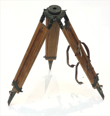 Lot 237 - A wooden and metal tripod, with leather...