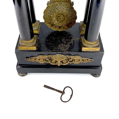 Lot 1709 - A French ebonised and ormolu portico clock.