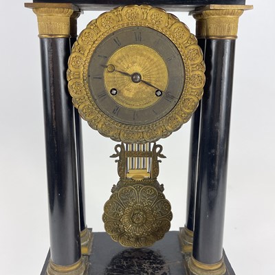 Lot 1709 - A French ebonised and ormolu portico clock.