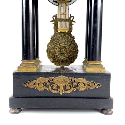 Lot 1709 - A French ebonised and ormolu portico clock.