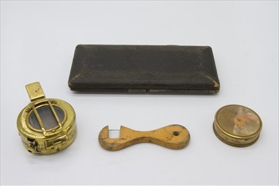 Lot 207 - A brass mariner's compass, a marching compass,...