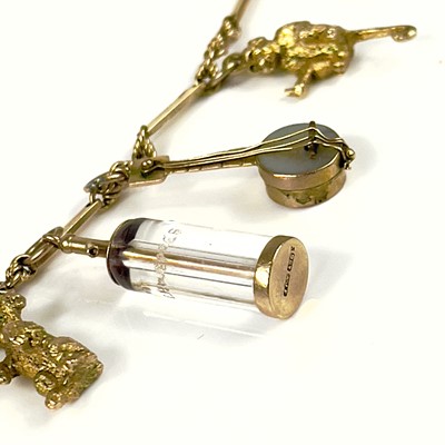 Lot 106 - A 9ct gold charm bracelet.