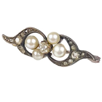 Lot 159 - A Edwardian rose gold diamond and pearl set scroll brooch.