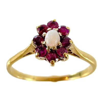 Lot 27 - An 18ct gold opal and garnet cluster ring.