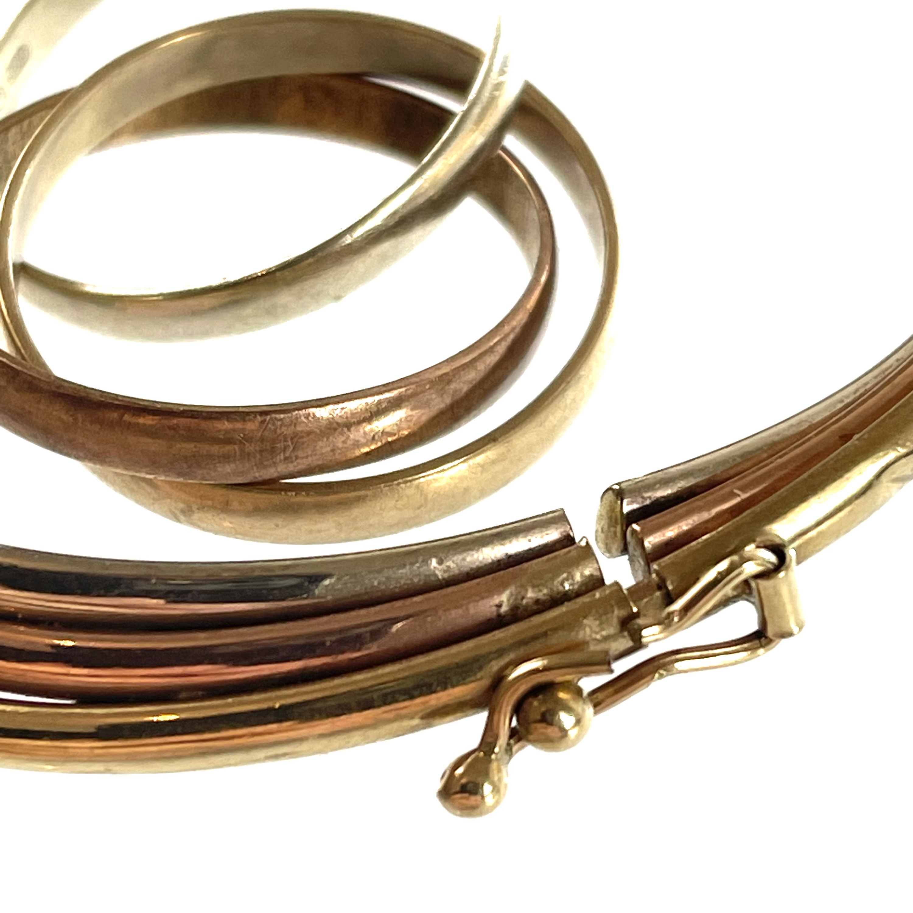 Lot 348 - A 9ct tri-colour gold bangle and a similar