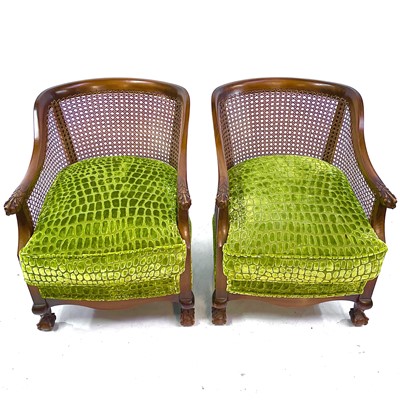 Lot 426 - A pair of Art Deco Bergere armchairs with curved backs and carved feather, talon and ball armrests.