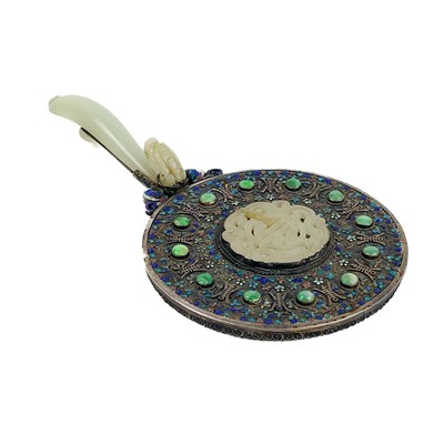 Lot 51 - A Chinese silver and enamel mirror mounted with jade, late 19th century.