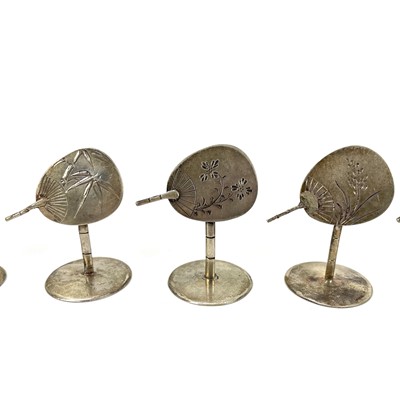 Lot 265 - A set of ten white metal place name holders shaped as hand fans.