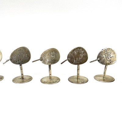 Lot 265 - A set of ten white metal place name holders shaped as hand fans.