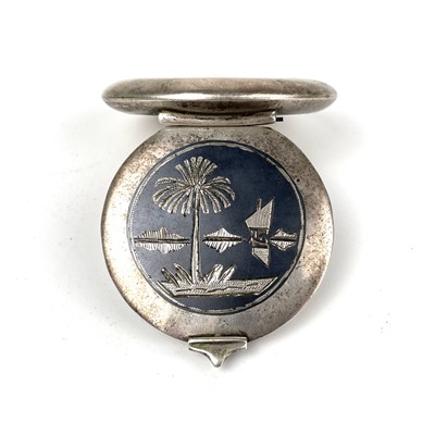 Lot 247 - An Egyptian silver niello circular compact.