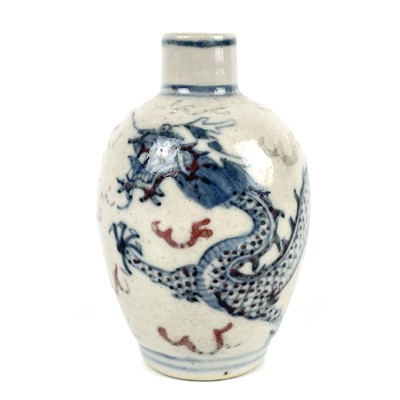 Lot 292 - A Chinese blue and white and copper red porcelain five-clawed dragon snuff bottle.