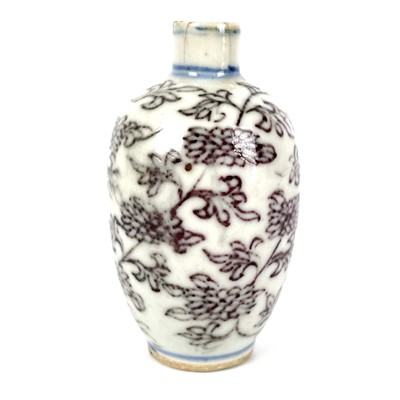 Lot 299 - A Chinese blue and white and copper red porcelain snuff bottle, Qing Dynasty, 1750-1850.