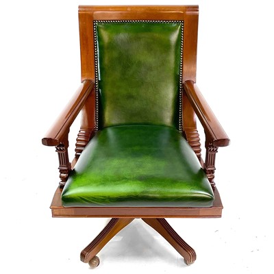 Lot 1919 - A mahogany and green leather upholstered swivel office chair.