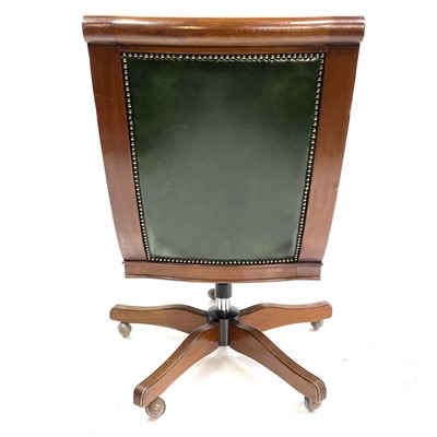 Lot 1919 - A mahogany and green leather upholstered swivel office chair.