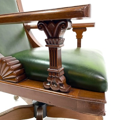 Lot 1919 - A mahogany and green leather upholstered swivel office chair.