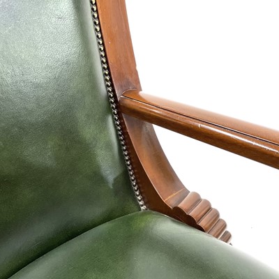 Lot 1919 - A mahogany and green leather upholstered swivel office chair.