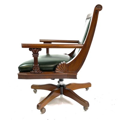 Lot 1919 - A mahogany and green leather upholstered swivel office chair.