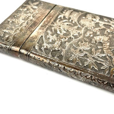 Lot 23 - An Burmese silver card case, decorated with trees and animals