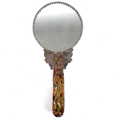 Lot 323 - A Chinese white metal jade-mounted mirror.