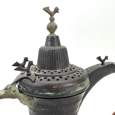 Lot 27 - An early 20th century Dallah pot with bird finials.