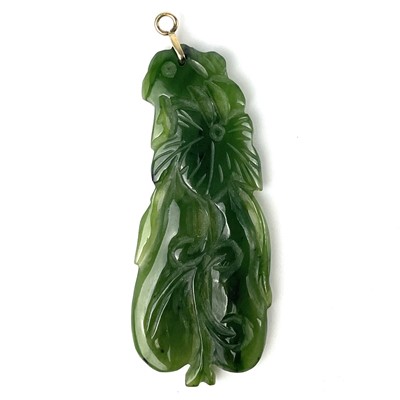 Lot 346 - A Chinese fruit carved green hardstone pendant.