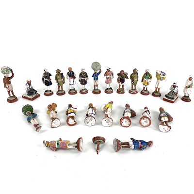 Lot 1050 - A collection of twenty-four Indian plaster and terracotta educational figures.