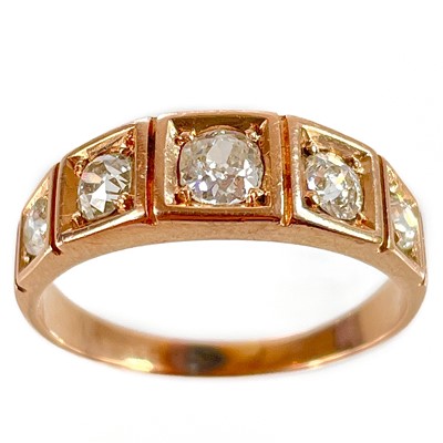 Lot 259 - An early 20th century high purity rose gold diamond set five stone ring.