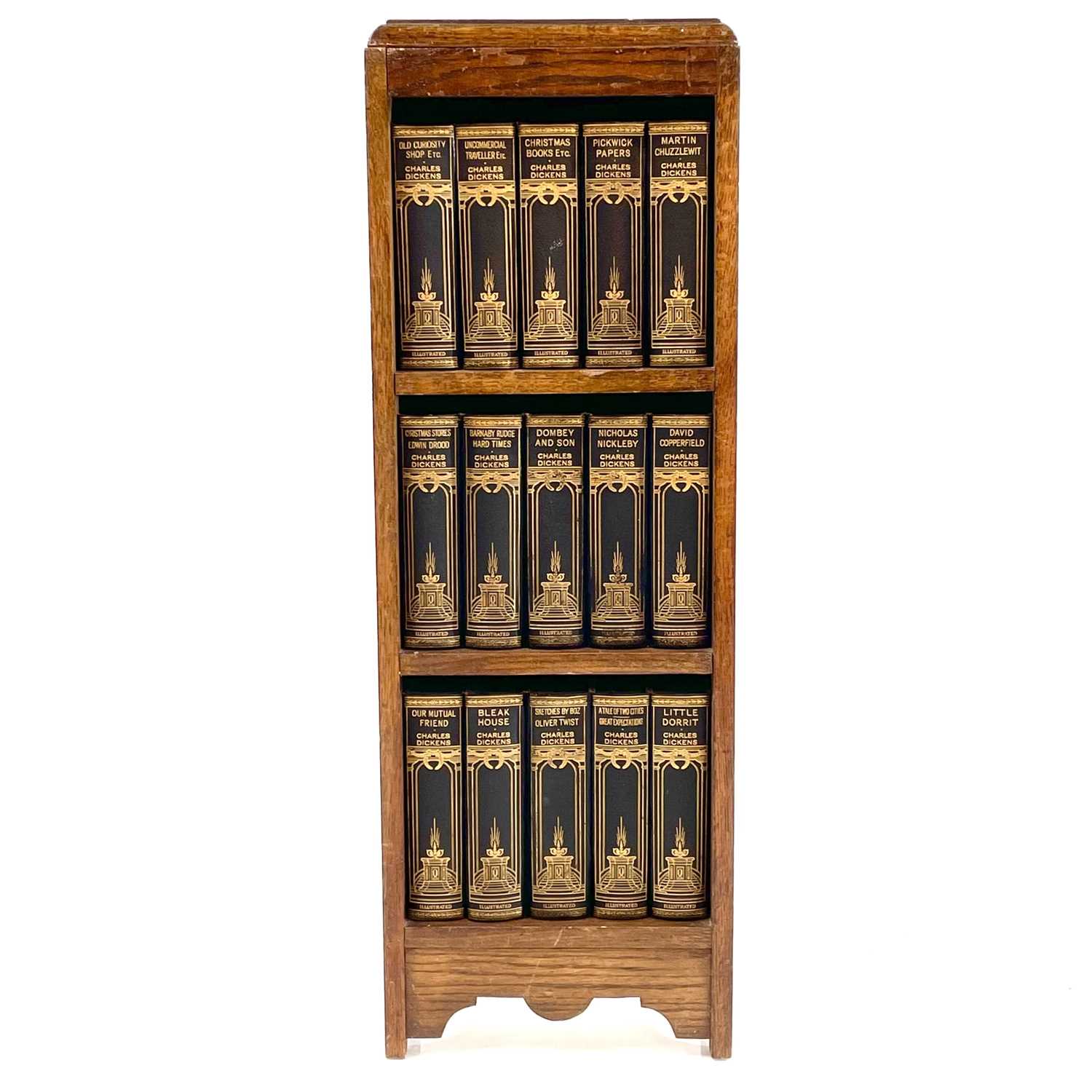 Lot 1877 - The works of Charles Dickens contained in a small oak bookcase.