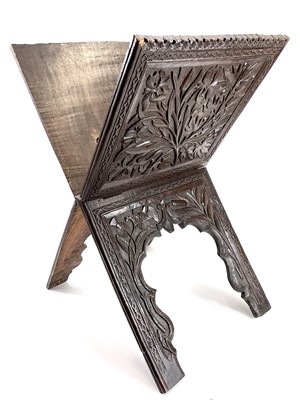 Lot 1059 - A carved hardwood folding Koran stand.