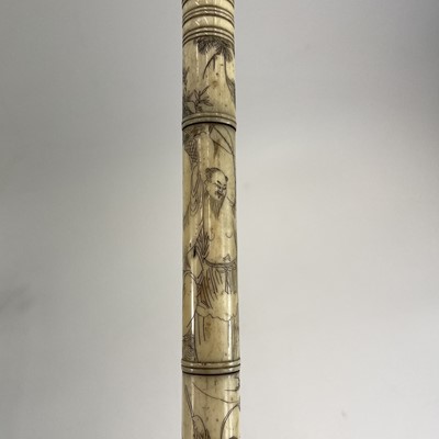 Lot 202 - A Chinese bone opium pipe decorated with scholars.