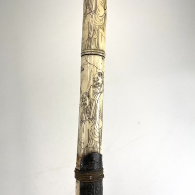 Lot 202 - A Chinese bone opium pipe decorated with scholars.