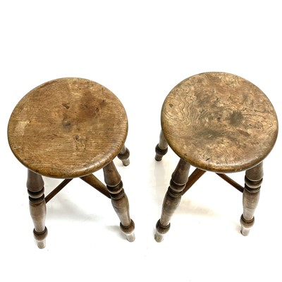 Lot 91 - Two Victorian elm circular top stools.