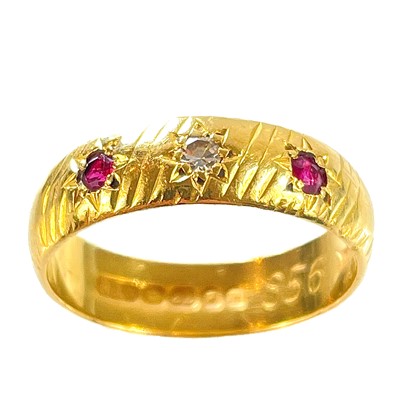 Lot 68 - A 1960's 22ct hallmarked gold diamond and ruby set three stone band ring.