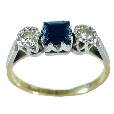 Lot 351 - An 18ct diamond and sapphire set three stone ring.