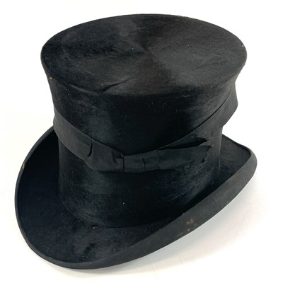 Lot 113 - A Victorian silk top hat and leather case.