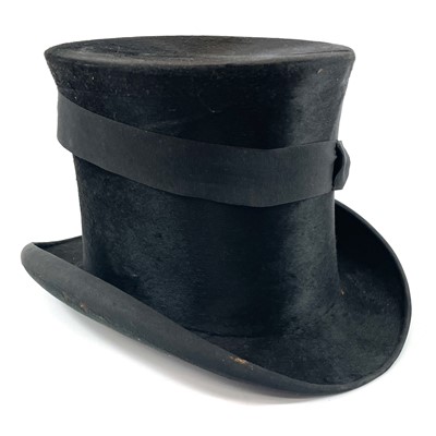 Lot 113 - A Victorian silk top hat and leather case.