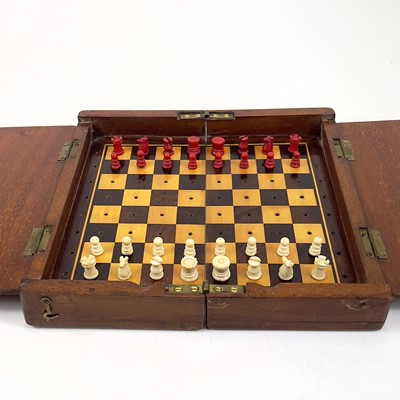 Lot 14 - A mahogany folding travel chess set.