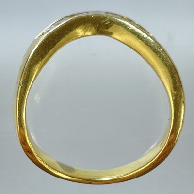 Lot 21 - A high purity gold diamond set eleven stone wishbone ring.