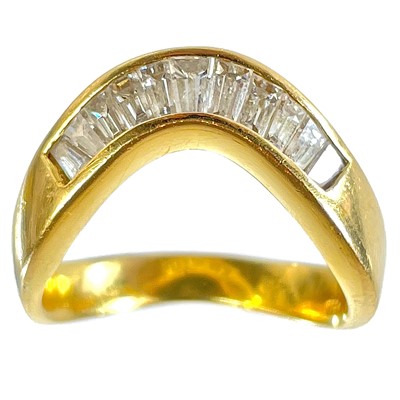 Lot 21 - A high purity gold diamond set eleven stone wishbone ring.