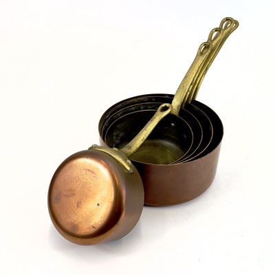 Lot 142 - A graduated set of five copper pans.