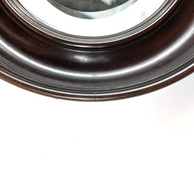 Lot 40 - A small late 19th century circular bevelled edge mirror in a mahogany frame.