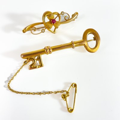 Lot 275 - A 1940's 15ct bar brooch and a 9ct key design '21' bar brooch.