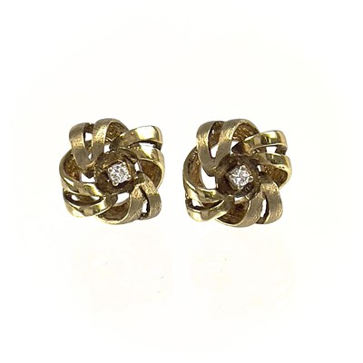 Lot 136 - A pair of 9ct diamond set stud earrings.