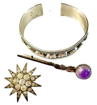 Lot 417 - An Arts & Crafts silver brooch set with a purple hard stone.