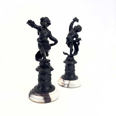 Lot 77 - A pair of bronze figures of cherubs.