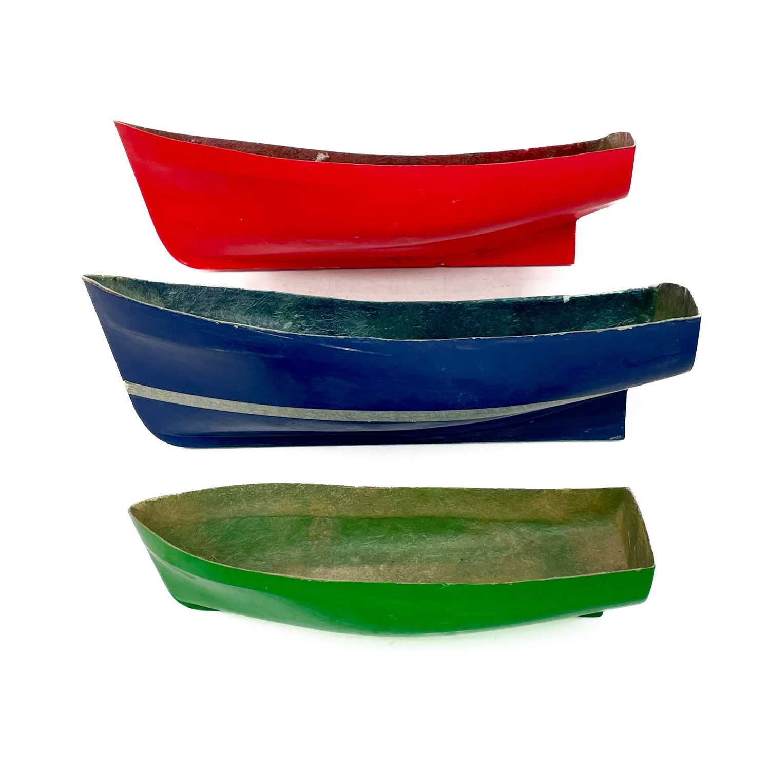 Lot 506 - Three painted fibreglass model boat hulls.