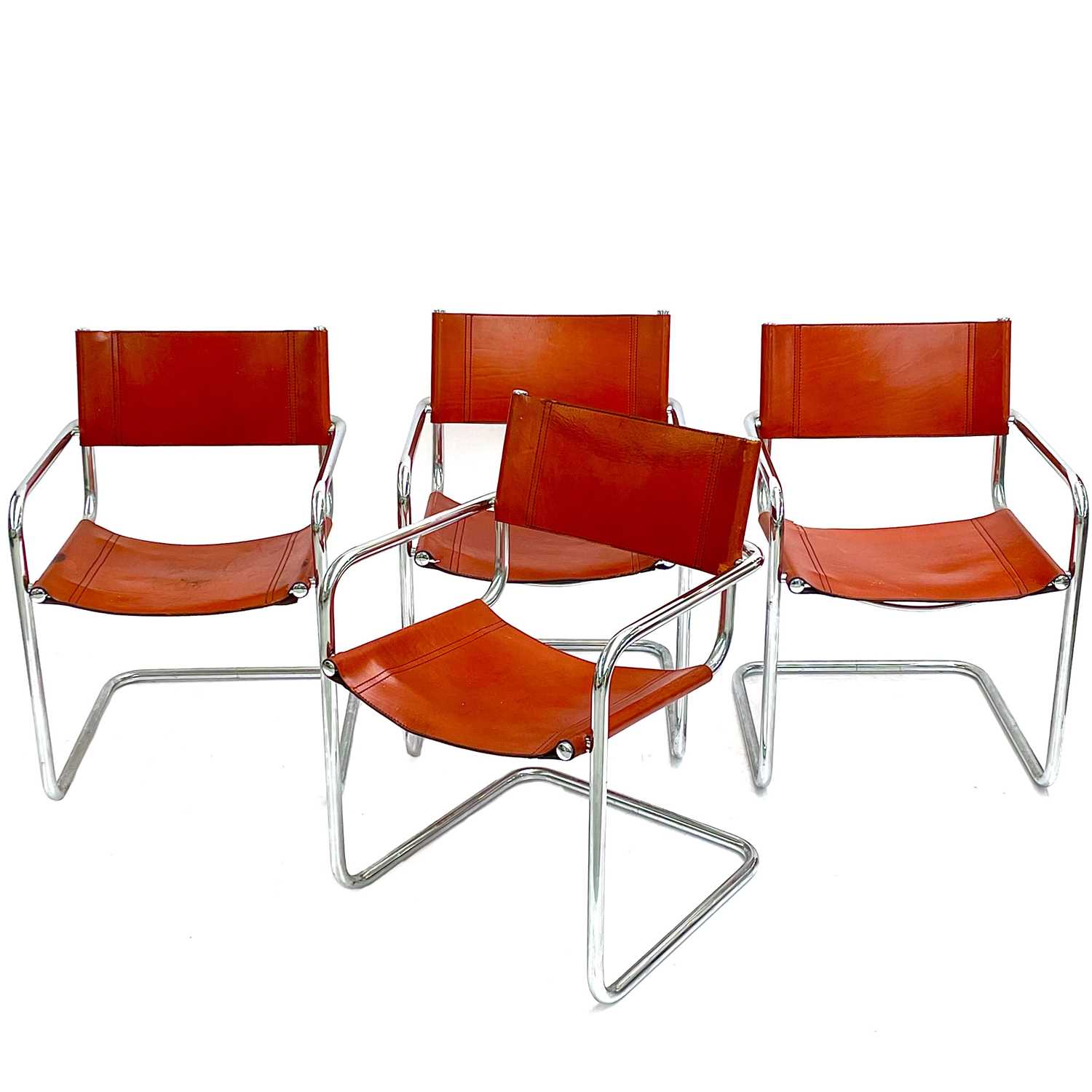 Lot 516 - A set of four Bauhaus-style chrome and leather cantilever dining chairs.