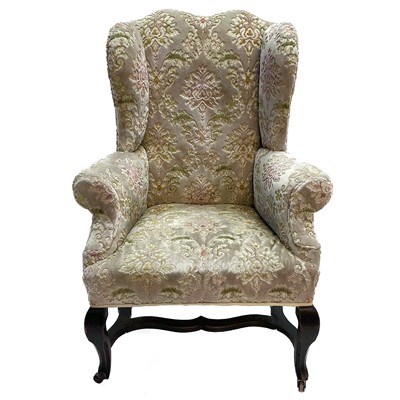 Lot 55 - A George III elm framed wing back armchair.