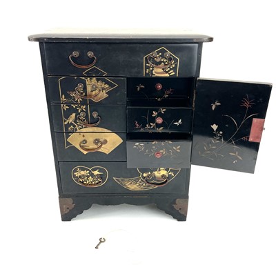 Lot 318 - A Japanese black lacquered small cabinet.